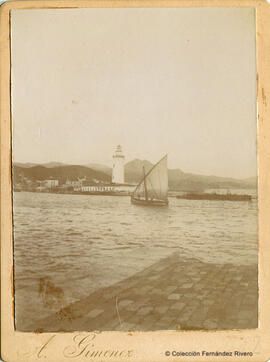 Málaga, barquito con una vela latina desplegada, entrando al puerto, frente a la farola. A. Giménez.